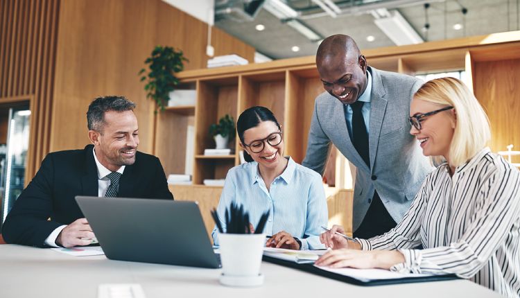 a group of accountants work together in an office meeting room
